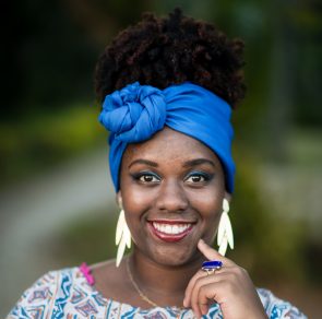 iStock 636178840 e1543953583331 295x292 - Afro brazilian woman wearing tunic and blue scarf