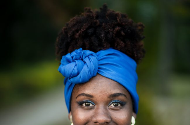 Afro brazilian woman wearing tunic and blue scarf