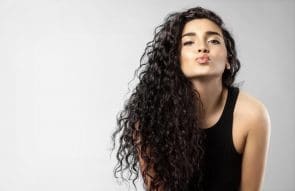 iStock 539953926 295x191 - Real woman with beauty black hair gives a kiss